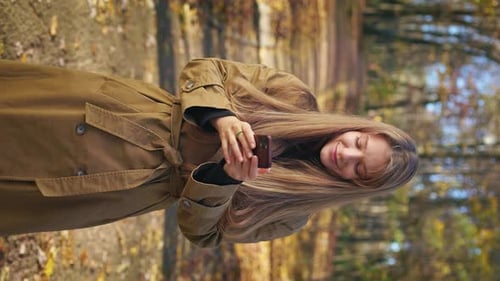 Elegant Young Female Wearing Fashionable Clothes Walking in Park