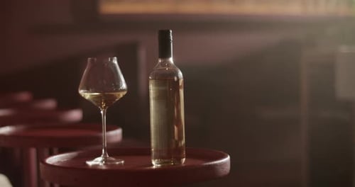 Wine Glass and Bottle on Table