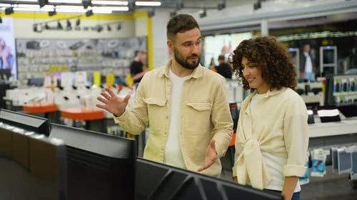 Couple Choosing a New Discounted Tv in Electronics Store