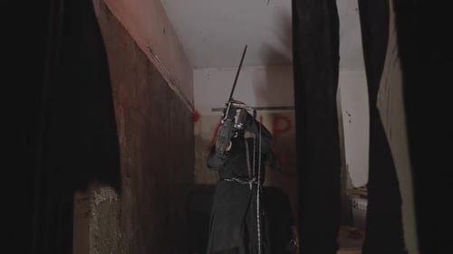 Dark Figure with Blades in Dilapidated Room