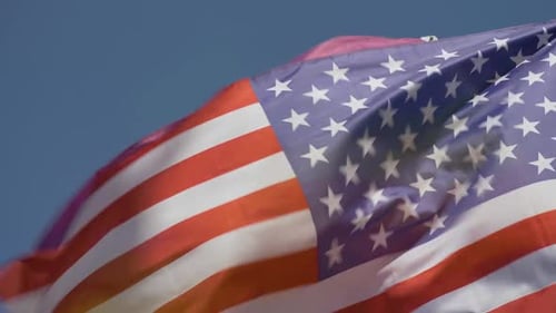 American and Pride Flags Waving in the Wind