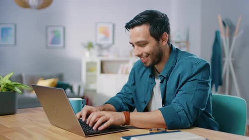 Man Working on Laptop in Bright Home Interior