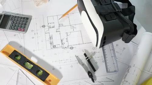 Architectural Blueprint and VR Headset on Desk
