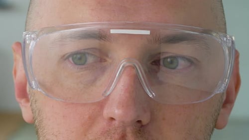 Man Wearing Safety Glasses Looking Around in Lab