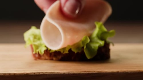 Delicious Lettuce and Meat Sandwich Preparation