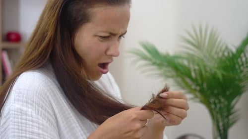 Woman Expresses Shock and Distress at Her Split Ends Grappling with Emotional Hair Loss and Damage