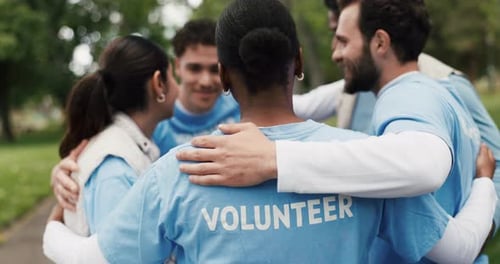Group of Volunteers Hug in Park