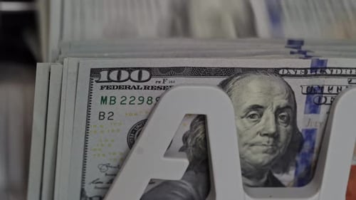 Close-up view of hundred dollar bills arranged in cash display