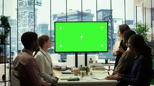 Diverse Group of Startup Employees Looking at Green Screen on Interactive Board