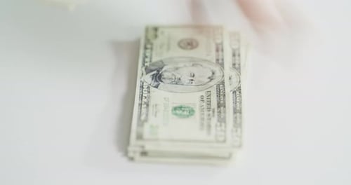 4k video footage on an unrecognizable businesswoman counting a stack of money inside her office
