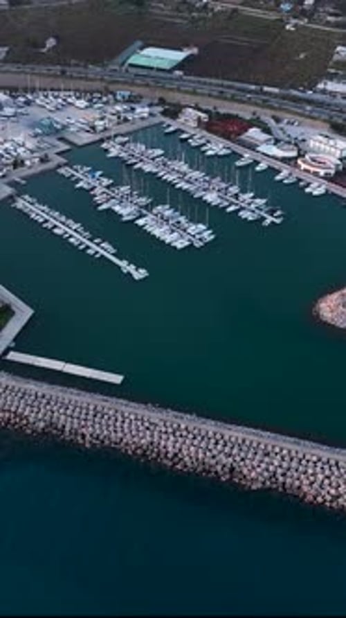 Vertical Video Aerial Perspective Alanya's Seaport and Yachts at Stunning Sunset