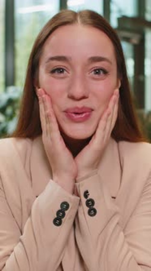 Caucasian Young Businesswoman Lady Looking at Camera Shocked By Sudden Victory in Office Lobby