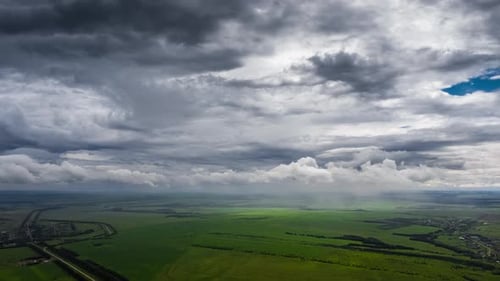Aerial View of Farmland Under Stormy Skies