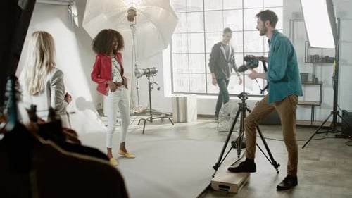 Model Posing During Photoshoot in Studio with Crew