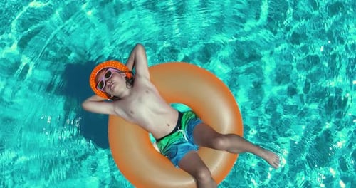 Summertime Vacation Kid with Inflatable Ring in Swimming Pool Top View Summer Vacation Summer