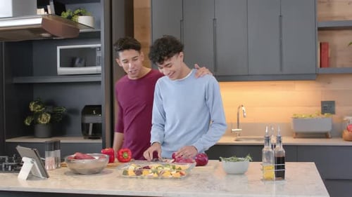 Young Adults Cooking Together in Modern Kitchen