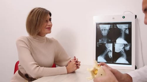 Doctor Consults with Patient about Spine Health
