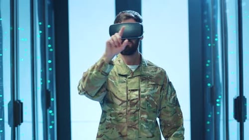 A Man in Military Uniform is Wearing a Virtual Reality Headset