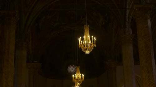 Golden Chandeliers Illuminating Gothic Cathedral Interior