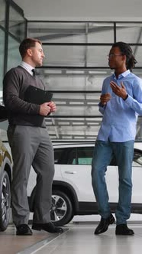 Men Talking at a Car Dealership
