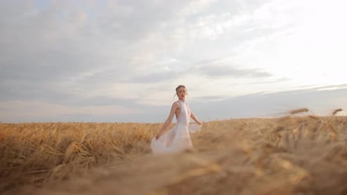 Female Wearing White Loose Dress Dancing Amidst Vast Field