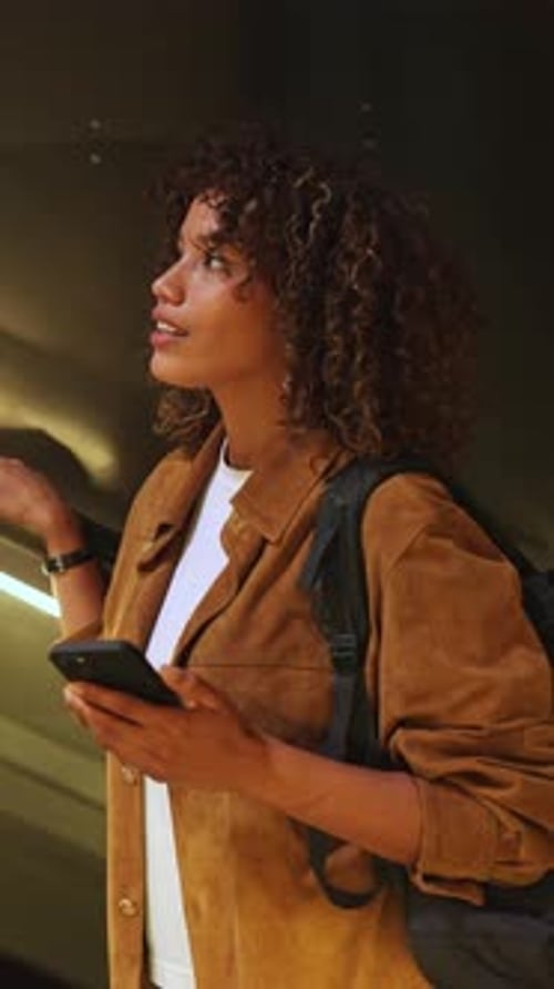 Stylish Woman Rides Escalator While Using Phone