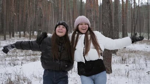 Two Happy Women in Snowy Winter Forest