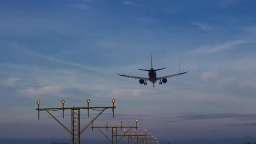 Airplane Landing at Airport Runway During Day