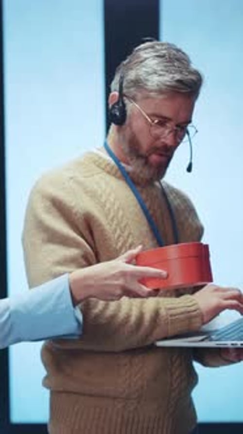 A Professional Woman Holding a HeartShaped Box in a Modern and Stylish Office Environment
