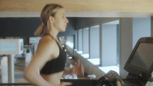 Woman Having Treadmill Workout in Gym