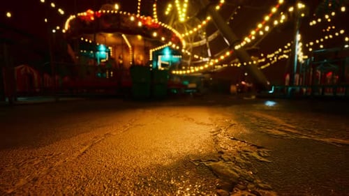 An Empty Amusement Park at Night with Glowing Lights and Deserted Rides