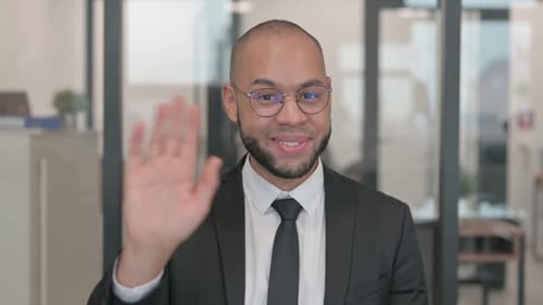 Portrait of Mixed Race Businessman Waving Hand to Say Hello