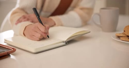 Woman, notebook and hands writing in home for journal, day schedule and checklist with planning