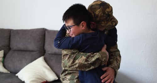 Touching reunion: Soldier embraces child warmly at home