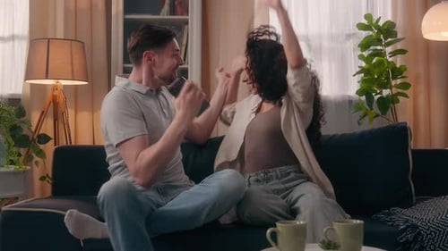 Couple Cheering Good News on Smartphone