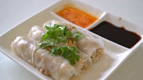 Rice Rolls with Sauce and Cilantro on Plate