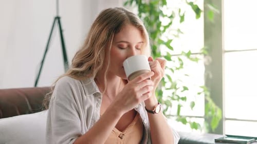 Woman Enjoys Coffee and Relaxation at Home