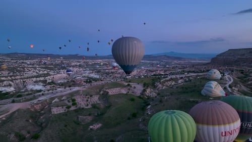 Hot Air Balloons Fly Over the Mountainous Landscape of Cappadocia Turkey