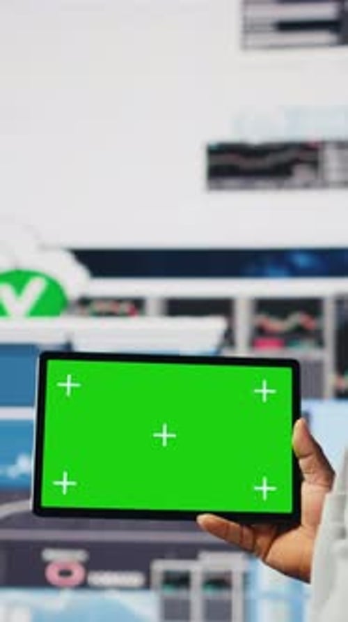 Vertical Video Black Businessman Holding Device with Green Screen and Examining Dashboards