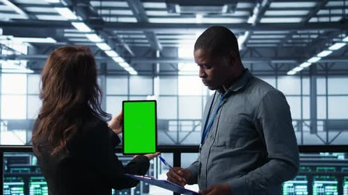 Workers Using Mockup Device in Server Room Checking Infrastructure Reliability