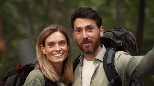 Happy Couple Enjoying Outdoor Adventure While Hiking in the Forest