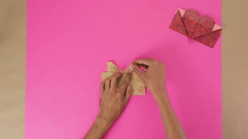 Hands folding decorative paper, arts and crafts