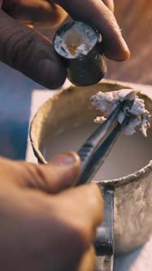Goldsmith Takes Off Detail From Container Over Cup Closeup