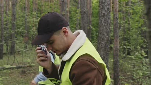 People Walking Through the Forest with Walkie Talkie