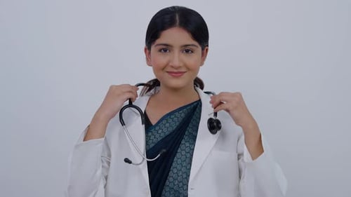 Indian Female Doctor Wearing Stethoscope and Smiling at Camera