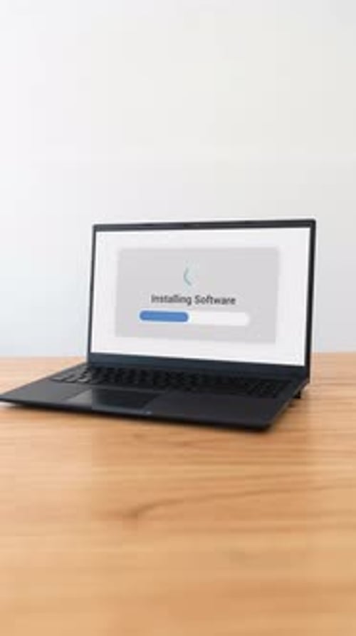 Installing new software on a laptop. Vertical shot.