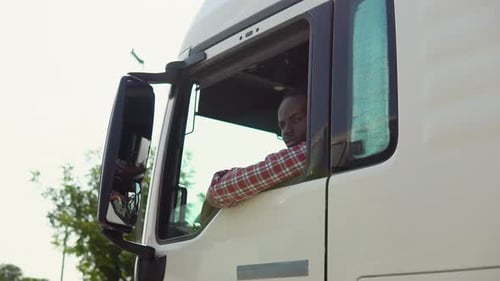 Black Truck Driver Sitting in His Truck Trucker Occupation Transportation Services