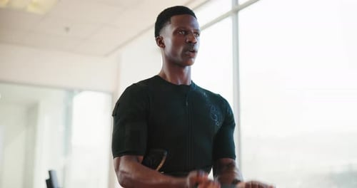 Black man, gym and biceps with band training or stretching for fitness, exercise and workout