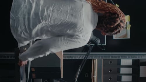 Investigator Reviews Evidence in Crime Scene Office