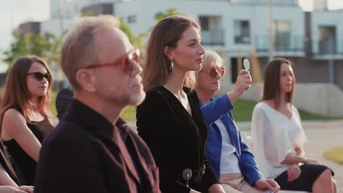 A Man Captures Friends or Family Joyfully Gathering in a Park